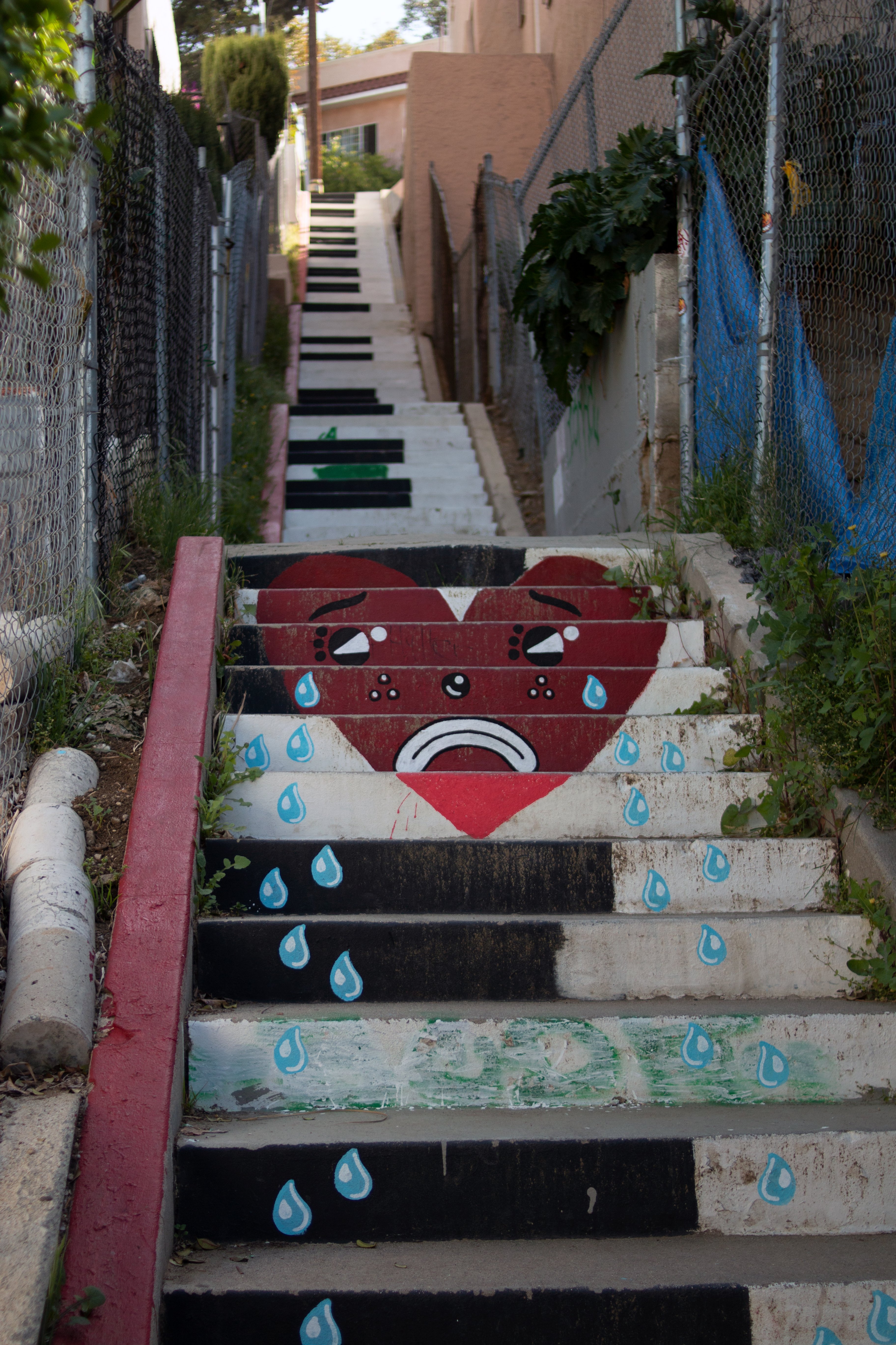 Painted staircase depicts piano keys and a crying heart.
